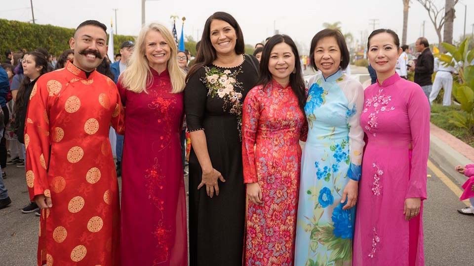 Murdy Staff at a Tet parade waring traditional ao dai